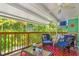 Inviting covered patio with comfortable seating and tropical views, perfect for relaxing and entertaining at 412 80Th St, Holmes Beach, FL 34217