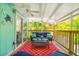 Charming covered patio featuring cozy furniture and tropical landscaping for tranquil outdoor living at 412 80Th St, Holmes Beach, FL 34217