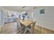 Open-concept dining area with modern lighting, a wooden table, and views into the bright, updated kitchen at 4130 N Albany Ave, Tampa, FL 33607