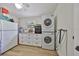 This laundry room features a full-size refrigerator, washer and dryer, and built-in cabinets at 4130 N Albany Ave, Tampa, FL 33607