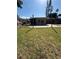 Backyard view featuring a lawn and the back of a house with a screened patio at 4218 Carson Ne St, St Petersburg, FL 33703
