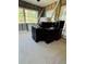 Living room with exposed beams and multiple windows awaiting renovation and customization at 4218 Carson Ne St, St Petersburg, FL 33703