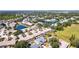 Serene aerial view of community featuring lakeside homes, mature trees, and landscaping at 4822 Hamlets Grove Dr, Sarasota, FL 34235