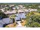 Aerial view of a charming neighborhood featuring mature trees, lush landscaping, and a sparkling pool at 4822 Hamlets Grove Dr, Sarasota, FL 34235