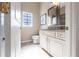 Well-lit bathroom featuring a decorative mirror, granite countertop, and ample cabinet space at 4822 Hamlets Grove Dr, Sarasota, FL 34235