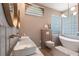 Modern bathroom with double sinks, freestanding tub, and elegant fixtures at 4822 Hamlets Grove Dr, Sarasota, FL 34235