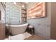 Relaxing bathroom featuring a modern tub, accent lighting and decorative shelves at 4822 Hamlets Grove Dr, Sarasota, FL 34235