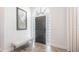 Elegant entryway with shiplap walls, transom window, and stylish decor and natural light at 4822 Hamlets Grove Dr, Sarasota, FL 34235