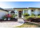 Welcoming front entrance with arched windows, decorative glass, and lush landscaping at 4822 Hamlets Grove Dr, Sarasota, FL 34235