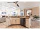 Spacious kitchen island with granite countertop, offering a view into the living area, perfect for casual dining at 4822 Hamlets Grove Dr, Sarasota, FL 34235