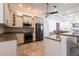 Well-equipped kitchen showcases stainless steel appliances and granite countertops, seamlessly connected to living areas at 4822 Hamlets Grove Dr, Sarasota, FL 34235
