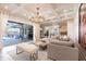 Bright and airy living room features a comfortable sectional sofa and seamless access to the outdoor seating area at 4822 Hamlets Grove Dr, Sarasota, FL 34235
