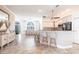 Open-concept living space with breakfast bar seating and a dining area bathed in natural light, creating an inviting atmosphere at 4822 Hamlets Grove Dr, Sarasota, FL 34235