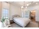 Cozy and bright main bedroom featuring a sliding barn door to ensuite bathroom at 4822 Hamlets Grove Dr, Sarasota, FL 34235