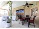 Relaxing covered patio featuring stylish furniture, ceiling fans, and a cozy dining area at 4822 Hamlets Grove Dr, Sarasota, FL 34235