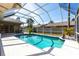 Inviting screened-in pool with sparkling blue water, surrounded by a patio and landscaping at 4822 Hamlets Grove Dr, Sarasota, FL 34235