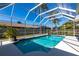Refreshing screened-in pool surrounded by ample deck space, palm trees, and privacy fencing at 4822 Hamlets Grove Dr, Sarasota, FL 34235