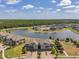 Scenic aerial view of a neighborhood nestled around a lake with lush green surroundings at 4828 San Martino Dr, Wesley Chapel, FL 33543