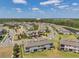 An aerial view showcases the stunning community layout with lush landscaping and serene water features at 4828 San Martino Dr, Wesley Chapel, FL 33543