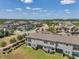 Aerial view of modern townhomes with screened-in lanais in a Gathering-friendly neighborhood with sidewalks and green space at 4828 San Martino Dr, Wesley Chapel, FL 33543