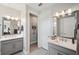 Elegant bathroom featuring double sinks with modern fixtures and clean, bright mirrors at 4828 San Martino Dr, Wesley Chapel, FL 33543
