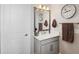 Clean bathroom with a single sink vanity and a well-lit mirror at 4828 San Martino Dr, Wesley Chapel, FL 33543