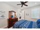 Comfortable bedroom featuring coastal decor, ceiling fan, and natural light from the window at 4828 San Martino Dr, Wesley Chapel, FL 33543