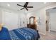 Bedroom features a blue patterned quilt on the bed and beach themed decorations at 4828 San Martino Dr, Wesley Chapel, FL 33543
