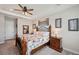 Serene bedroom featuring comfortable furniture, a decorative mirror and a ceiling fan at 4828 San Martino Dr, Wesley Chapel, FL 33543