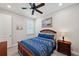 Cozy bedroom with a dark wood bed frame, matching nightstand, and decorative lamp at 4828 San Martino Dr, Wesley Chapel, FL 33543