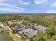Expansive aerial view highlighting tennis courts, pool, and community amenities against a backdrop of lush trees at 4828 San Martino Dr, Wesley Chapel, FL 33543