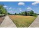 A well-manicured green space offers a peaceful retreat with walking paths and comfortable seating at 4828 San Martino Dr, Wesley Chapel, FL 33543