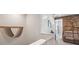 Hallway featuring neutral walls with unique wall art and views into the media room at 4828 San Martino Dr, Wesley Chapel, FL 33543