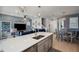 Open-concept kitchen featuring quartz countertops, stainless steel appliances, modern lighting and an adjacent Gathering room at 4828 San Martino Dr, Wesley Chapel, FL 33543