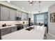 Bright kitchen features gray cabinetry, stainless steel appliances, a center island and an adjacent office space at 4828 San Martino Dr, Wesley Chapel, FL 33543