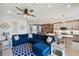 Open-concept Gathering room with modern lighting, an area rug, a large sofa and a kitchen island at 4828 San Martino Dr, Wesley Chapel, FL 33543