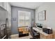 Bright home office with neutral walls, a window with privacy shutters, and modern desk with office chair at 4828 San Martino Dr, Wesley Chapel, FL 33543
