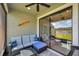 Covered patio with comfortable seating, ceiling fan, and sliders opening to the backyard at 4828 San Martino Dr, Wesley Chapel, FL 33543