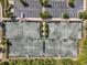 Aerial view of a community tennis courts and parking lot at 4828 San Martino Dr, Wesley Chapel, FL 33543