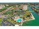 An aerial view of a beautiful waterfront community featuring lush landscaping, pool, tennis courts, and marina at 4900 Brittany S Dr # 811, St Petersburg, FL 33715