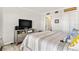 Bedroom with an entertainment center, soft, striped bedding, and neutral decor at 4900 Brittany S Dr # 811, St Petersburg, FL 33715