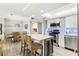 Modern kitchen features stainless steel appliances, a center island with seating, and an adjacent dining area at 4900 Brittany S Dr # 811, St Petersburg, FL 33715