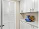 Well-organized laundry room with ample storage cabinets, a countertop, and stylish finishes at 4900 Brittany S Dr # 811, St Petersburg, FL 33715