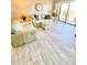 Cozy living room with a comfortable sofa, ottoman, side tables, and a sliding glass door leading to a balcony at 4900 Brittany S Dr # 811, St Petersburg, FL 33715