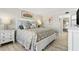 Comfortable main bedroom with a well-dressed bed and a view to an ensuite bath at 4900 Brittany S Dr # 811, St Petersburg, FL 33715