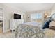 Bright bedroom with a comfortable bed, dresser, and a window offering a scenic view at 4900 Brittany S Dr # 811, St Petersburg, FL 33715