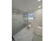 Modern bathroom with walk-in shower, granite countertop vanity, and marble-patterned flooring at 547 16Th S Ave, St Petersburg, FL 33701