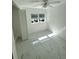 Small, tidy bedroom with white walls and floors, and a bright window at 547 16Th S Ave, St Petersburg, FL 33701