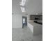 Modern kitchen with gray cabinets, stainless steel appliances, and an island featuring white quartz countertops at 547 16Th S Ave, St Petersburg, FL 33701