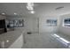 Bright living room with marble floors next to a kitchen area, featuring natural light from windows at 547 16Th S Ave, St Petersburg, FL 33701